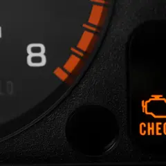 Pomarańczowa kontrolka "CHECK ENGINE" na desce rozdzielczej Hondy Civic. Znaczenie tej kontrolki może wskazywać na problem z silnikiem.