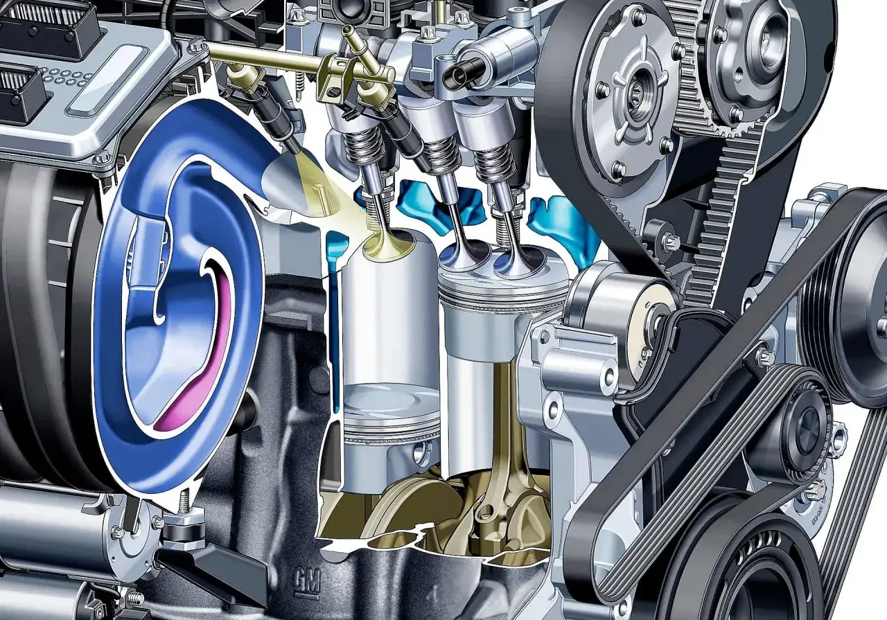 Przekrój silnika z widocznymi tłokami, zaworami i paskiem rozrządu. Ilustracja pokazuje mechanizm, który może prowadzić do zjawiska, jakim jest spalanie stukowe.